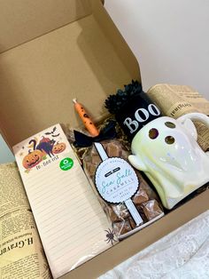 a box filled with halloween items on top of a bed