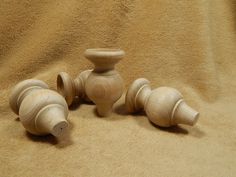 three wooden vases sitting on top of a blanket