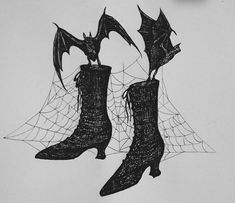 two boots with bats on them are hanging from a web