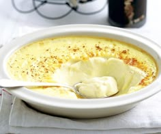 a white bowl filled with soup on top of a table