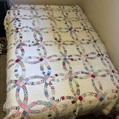 a bed with a quilt on top of it