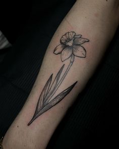 a black and white photo of a flower on the left arm with an arrow in it