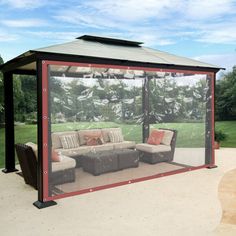 an outdoor living area with couches and a gazebo in the middle of it