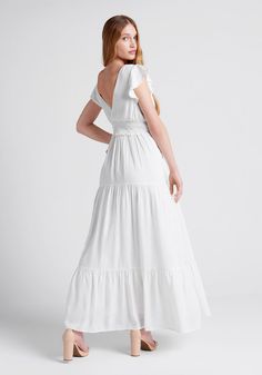 With notes of cottagecore and delicate detailing, this boho-chic white maxi dress from our ModCloth namesake label is effortlessly elegant. Made from a cotton poplin weave, this darling dress boasts willowy, dual-layer flutter sleeves, a V-neckline with a deep V-line surplice back, and shirred detailing throughout the fitted bodice. The empire waist of this beautiful fully-lined dress is accentuated by a smocked waistband with ruffle detailing that provides ease-of-fit and gives way to a flowy tiered maxi skirt. 100% Cotton. Fabric does not provide stretch Stretch provided at smocked waistband. Fits true to size. Hand wash (recommended). Imported | ModCloth Notes Of Grace Maxi Dress in White White Maxi Dress With Smocked Back, Flowy White Maxi Dress With Smocked Back, White Cotton Maxi Dress With Ruffles, White Tiered Maxi Dress For Daywear, White Maxi Dress With Smocked Back For Daywear, White Tiered Maxi Dress For Garden Party, White Flowy Cotton Maxi Dress, White Cottagecore Maxi Dress For Garden Party, Feminine Cotton Maxi Dress