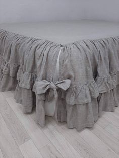 a bed with ruffled bedskirt on top of it