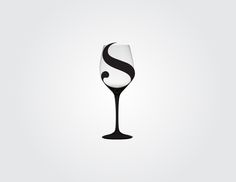 a black and white wine glass sitting on top of a table