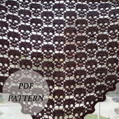 a crocheted shawl with circles on it