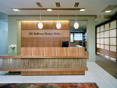 an office lobby with a wooden reception desk