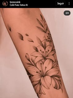 a black and white flower tattoo on the arm