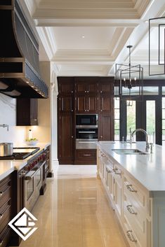 a large kitchen with marble counter tops and stainless steel appliances in the center, along with dark wood cabinets