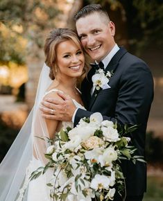 a bride and groom hugging each other