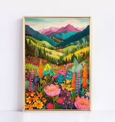 a painting hanging on the wall in front of a white wall with flowers and mountains