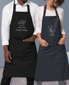 two people standing next to each other wearing aprons