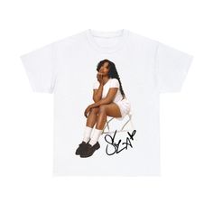 a white t - shirt with an image of a woman sitting on top of a chair