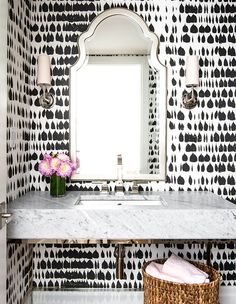 a white sink sitting under a bathroom mirror next to a wall mounted faucet