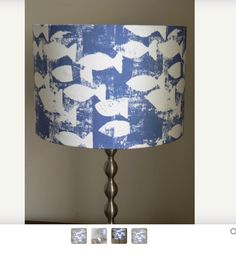 a lamp that is sitting on top of a table next to two pictures with the same color