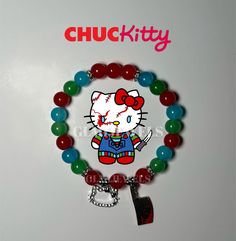 a hello kitty bracelet with beads and charms on the front, along with a tag that says chuck kitty