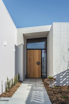 a house with a wooden door and white walls