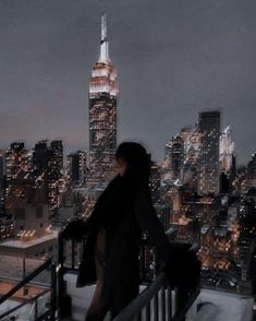 a woman standing on top of a building looking down at the cityscape and skyscrapers