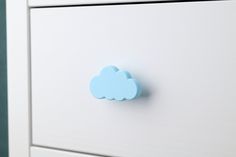 a white dresser with a blue cloud on it