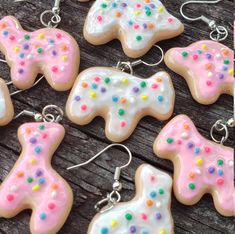 several decorated cookies sitting on top of a wooden table