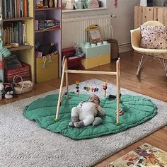 a child's play area with toys and bookshelves in the background,