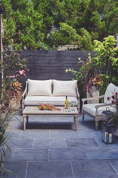 an outdoor seating area with two chairs and a table