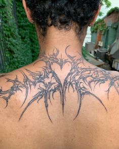 the back of a woman's neck with tattoos on it