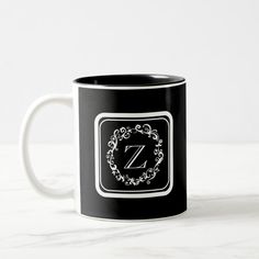 a black and white coffee mug with the letter z on it