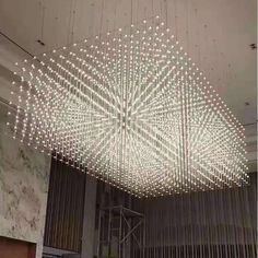 a large chandelier hanging from the ceiling in a room with many lights on it