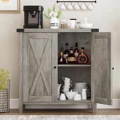 an open cabinet with dishes and cups on it next to a wall mounted coffee maker