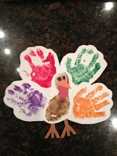 a turkey made out of hand prints sitting on top of a counter