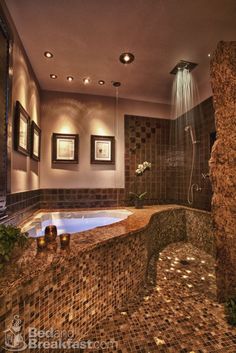 a bathroom with a large jacuzzi tub next to a sink and shower head