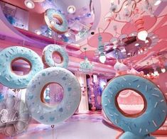 an artistic display with donuts and chandeliers hanging from the ceiling