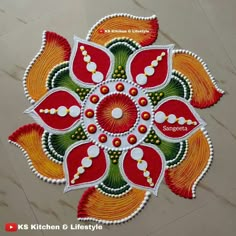 an intricate design on the floor with red, yellow and green flowers in it's center