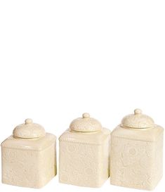 three white ceramic canisters with lids