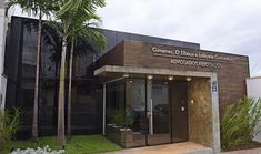 the entrance to an office building with palm trees