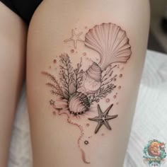 a woman's thigh with shells and starfishs on the side, while she has