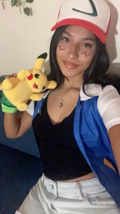 a woman holding a stuffed pikachu toy