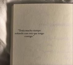 an open book with a poem written in spanish