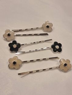 Gorgeous pair of 1990s flower kirby grips. Made from silver tone metal in either cream and black, white with a black centre or black with a white centre.  Each kirby measures 5.8cm length Selling lots of hair accessories from the 50s-80s Check out the rest of my vintage wares on Etsy  https://www.etsy.com/uk/shop/Rhubarbjumbleshop Or my website to get full details of our high street shop in Bristol UK  http://rhubarbjumble.com/ Follow us on Facebook/instagram/Twitter  https://m.facebook.com/RhubarbJumble/ https://www.instagram.com/rhubarbjumble/ https://mobile.twitter.com/vintagebristol ❤️Thank you for shopping with Rhubarb Jumble, your custom makes all the difference to us independents❤️ Etsy Hair Accessories, 80s Things, Pink Flower Hair Clip, Bristol England, Hair Slides, Cream Flower, High Street Shops, Bristol Uk, Hair Slide