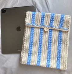 an ipad case made out of crochet with a blue and white stripe on it