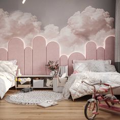 two beds in a bedroom with pink walls and clouds painted on the wall behind them