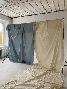 an empty room with two drapes in it