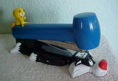 a toy is sitting on top of a skateboard and some other toys are laying next to it