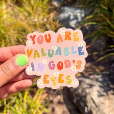 someone holding up a sticker that says, you are valuable i'm god's eyes