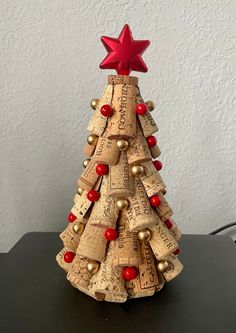 a small christmas tree made out of wine corks and red star on the top