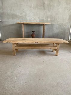 a wooden table sitting on top of a cement floor