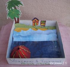 a cardboard box with a house and palm tree in it