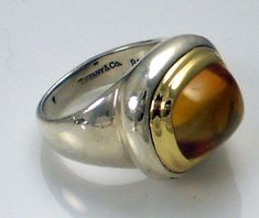 Authentic Tiffany & Co. Rare Huge Vintage Paloma Picasso Sterling Silver & 18k Yellow Gold Loaf Shape Citrine Statement Ring. This lovely size 5 ring  is fully engraved: Tiffany & Co 925 750 and signed: Paloma Picasso. It weighs 10.35 grams. The huge loaf shape golden yellow citrine is absolutely stunning. It is in excellent condition and 100 % authentic. Perfect for a collector. Please visit my ebay store for unique estate jewelry. Thank you. Paloma Picasso Jewelry, Picasso Jewelry, Paloma Picasso, Yellow Citrine, Citrine Ring, Golden Yellow, Paloma, Estate Jewelry, Product Photography